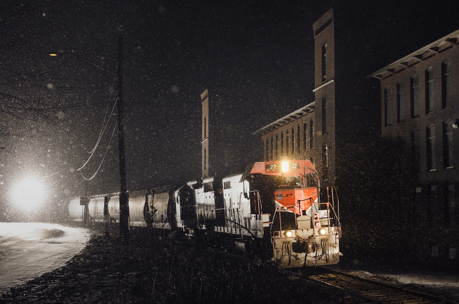 BAR 22 passes a new england mill in a snow storm at night