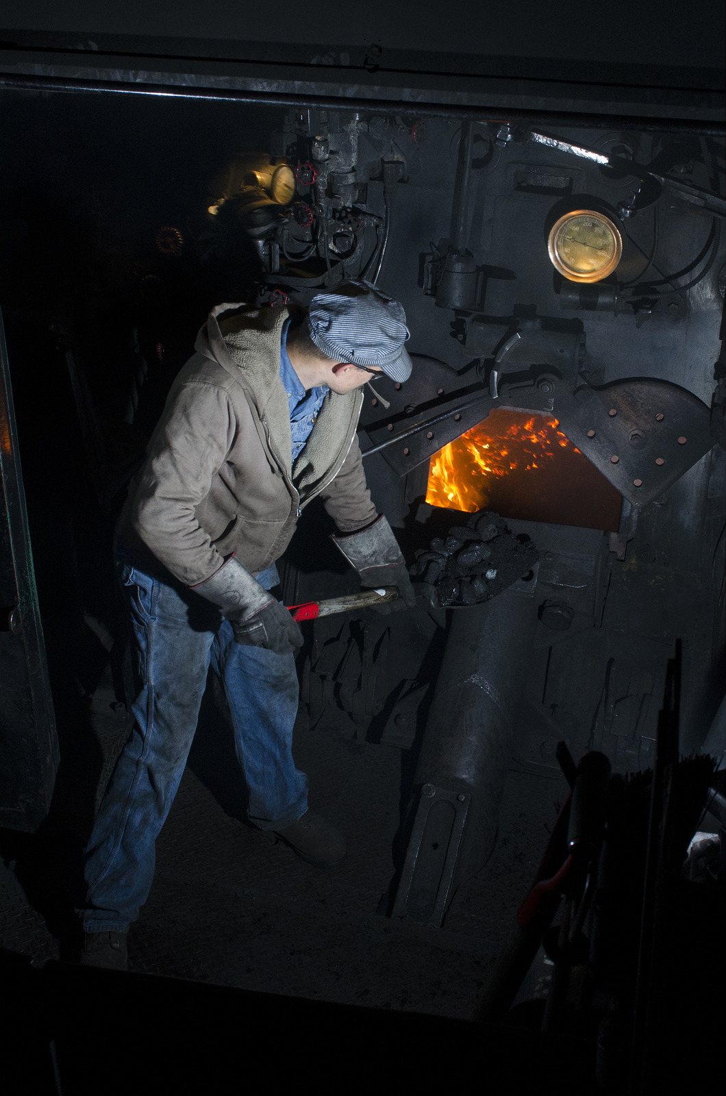 shoveling coal into the firebox